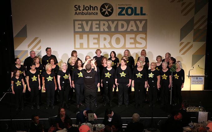 Rock choir singing on stage at Everyday Heroes awards evening.